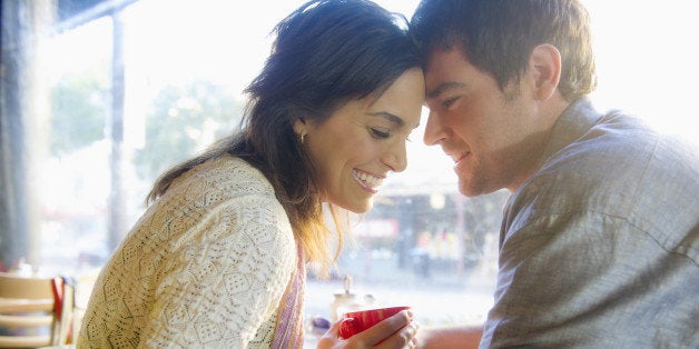 Couple holding hands in cafe