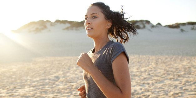 Young woman running at sunset on Australian beach