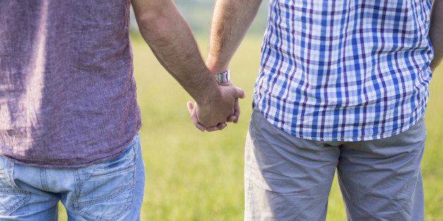 Close up of Gay couple holding hands outdoor