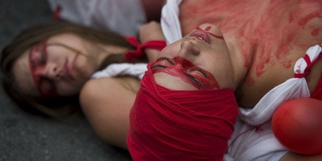 Activists perform in favour of the legalization of abortion as part of International Women's Day in Sao Paulo, Brazil on March 8, 2015. AFP PHOTO / NELSON ALMEIDA (Photo credit should read NELSON ALMEIDA/AFP/Getty Images)