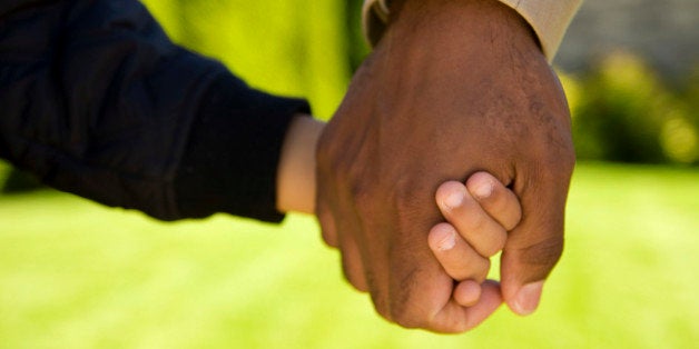 Father holding son's hand