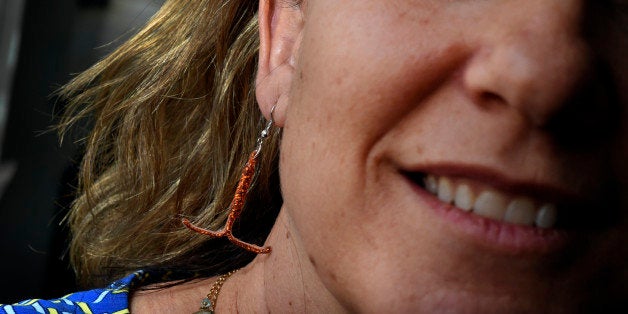 DEVER, CO. - MARCH 12: Colorado State Rep. KC Becker poses for a portrait with an earring fashioned after an IUD at the State