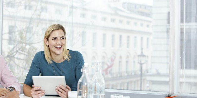 Business woman working on a digital tablet.