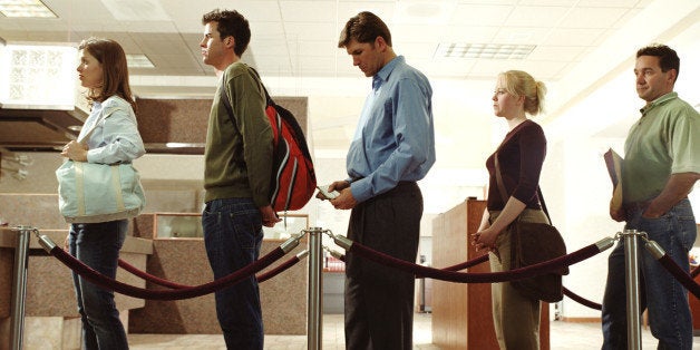 Customers standing in line in bank