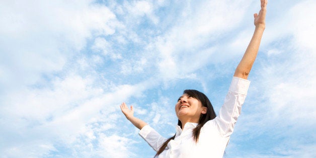 Businesswoman with arms raised