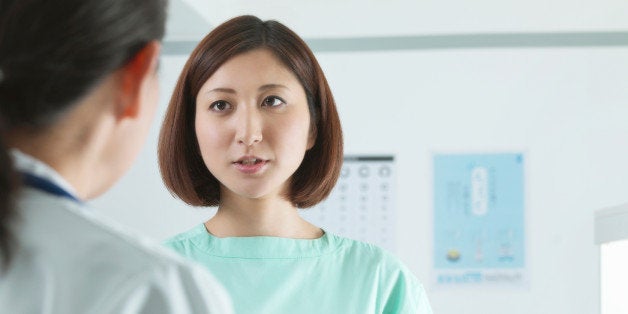 Doctor in discussion with patient in examination room