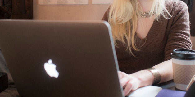 a woman working intensely at her laptop