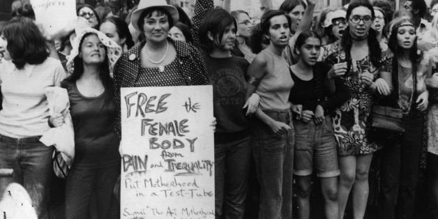 Bella Abzug (1920 - 1998) is running for Congress and is one of the chief organisers of the Women's Liberation Day parade in New York, on the 50th anniversary of women winning the vote in the United States. She is carrying an anti-motherhood sign reading 'Free the female body from pain and inequality. Put motherhood in a test-tube'. (Photo by Keystone/Getty Images)