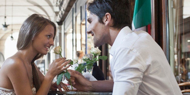 Caucasian man giving girlfriend a rose