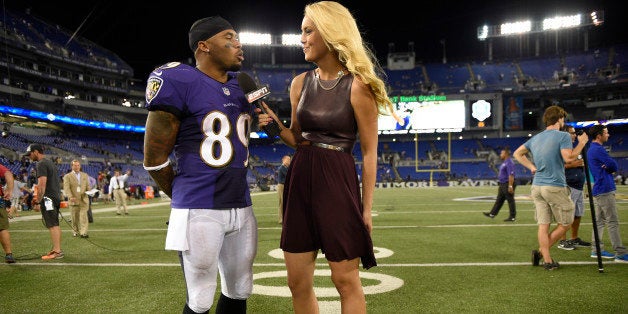 FILE - In this Sept. 11, 2014, file photo, Baltimore Ravens wide receiver Steve Smith (89) is interviewed after an NFL football game against the Pittsburgh Steelers by ESPN reporter Britt McHenry, right, in Baltimore. ESPN has suspended reporter Britt McHenry after a video surfaced of her insulting a towing company clerk's intelligence, job and appearance. ESPN spokesman Josh Krulewitz said Thursday, April 16, that McHenry has been suspended for a week. (AP Photo/Nick Wass, File)