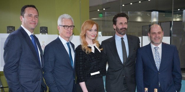 (L-R) AMC President Charlie Collier, actor John Slattery, who played the character 'Roger Sterling' in the AMC television series 'Mad Men;' actress Christina Hendricks, who played 'Joan Harris;' actor Jon Hamm, who played 'Donald Draper;' and creator, writer and executive producer Matthew Weiner, pose infront of of the objects from the series which are being presented to the Smithsonian National Museum of American History on March 27, 2015 in Washington, DC. AFP PHOTO/MANDEL NGAN (Photo credit should read MANDEL NGAN/AFP/Getty Images)