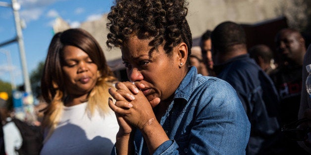 BALTIMORE, MD - APRIL 28: A woman cries after being prayed over during a protest near the CVS pharmacy that was set on fire yesterday during rioting after the funeral of Freddie Gray, on April 28, 2015 in Baltimore, Maryland. Gray, 25, was arrested for possessing a switch blade knife April 12 outside the Gilmor Houses housing project on Baltimore's west side. According to his attorney, Gray died a week later in the hospital from a severe spinal cord injury he received while in police custody. (Photo by Andrew Burton/Getty Images)