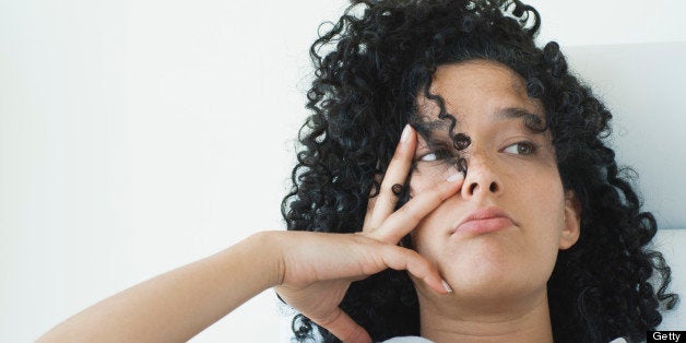 Young woman with bored expression on face