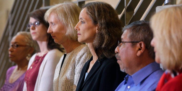 Members of the Austin city council listen to city manager Marc Ott during a news conference at City Hall, Wednesday, May 13,