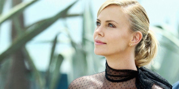 CANNES, FRANCE - MAY 14: Charlize Theron looks up after she leaves a photocall for 'Mad Max: Fury Road' during the 68th annu