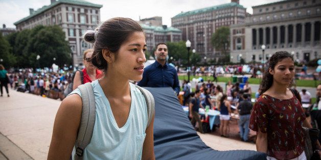 NEW YORK, NY - SEPTEMBER 05: Emma Sulkowicz (L), a senior visual arts student at Columbia University, carries a mattress, with the help of three strangers who met her moments before, in protest of the university's lack of action after she reported being raped during her sophomore year on September 5, 2014 in New York City. Sulkowicz has said she is committed to carrying the mattress everywhere she goes until the university expels the rapist or he leaves. The protest is also doubling as her senior thesis project. (Photo by Andrew Burton/Getty Images)