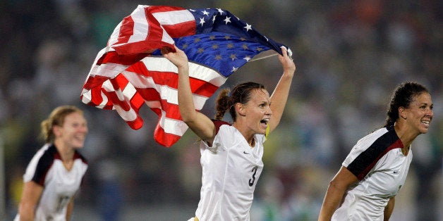 The United States' Christie Rampone, center, Shannon Boxx, right, and Lori Chalupny, celebrate after beating Brazil 1-0 in the women's soccer gold medal match at the Beijing 2008 Olympics in Beijing, Thursday, Aug. 21, 2008. (AP Photo/Silvia Izquierdo)