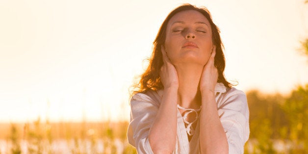 young woman practicing yoga on...