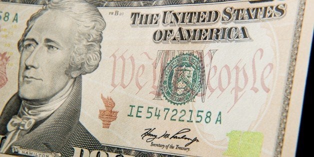 A close-up of the front of the US 10-dollar bill bearing the portrait of Alexander Hamilton, America's first Treasury Secreta