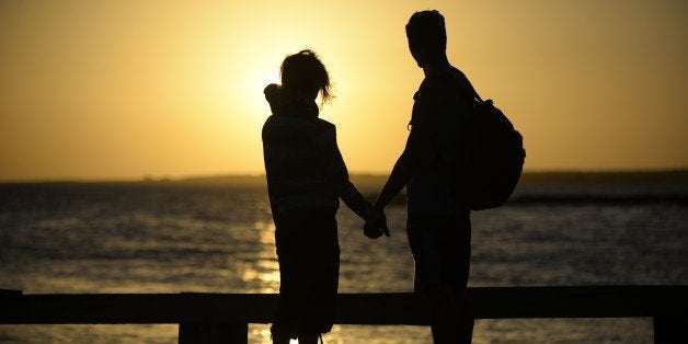 A couple hold hands near the shore of El Yaque Beach, Nueva Esparta state, Margarita Island, Venezuela on January 31, 2014. A