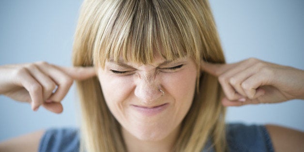 Woman blocking ears with fingers