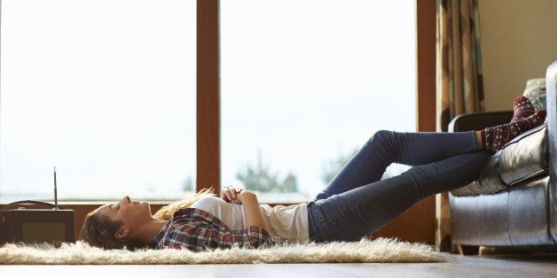 Woman relaxing and listening to radio at home.