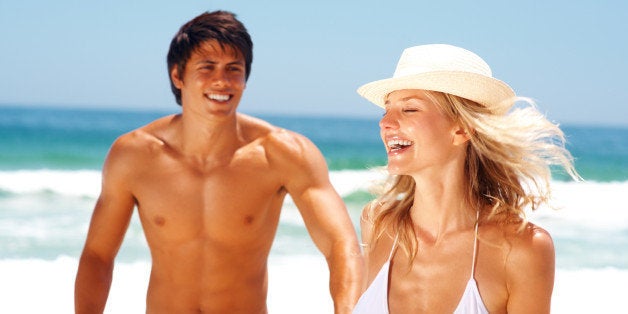 Attractive young couple having fun at the beach