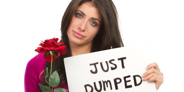 woman holding a sign that says 'just dumped' as a relationship break up concept