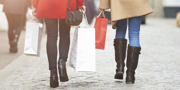 Woman walking along street with Christmas shopping