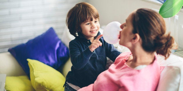 Small boy playing with his mother