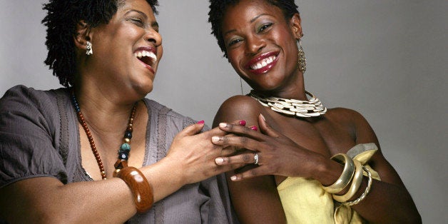 Portrait of happy mature and young African American women, studio shot