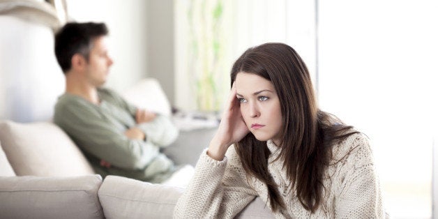 Young couple having relationship difficulties, shallow depth of field focus on foreground