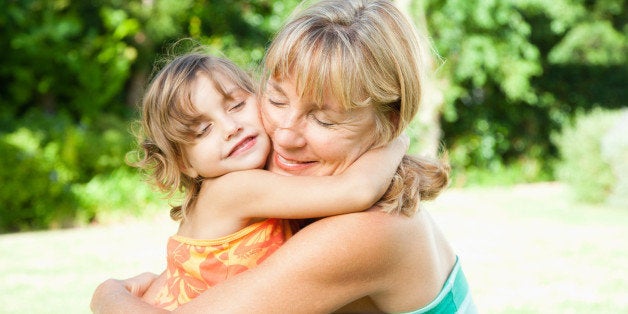 A grandmother and granddaughter being affectionate