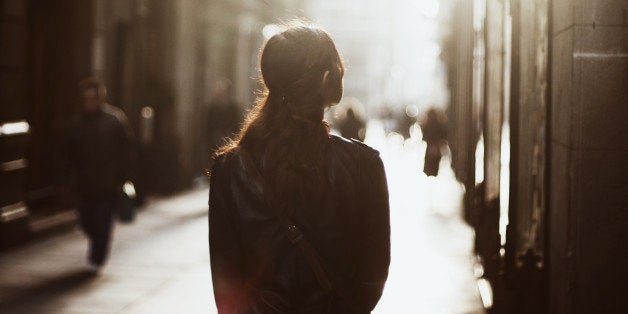 Girl walking down misty street