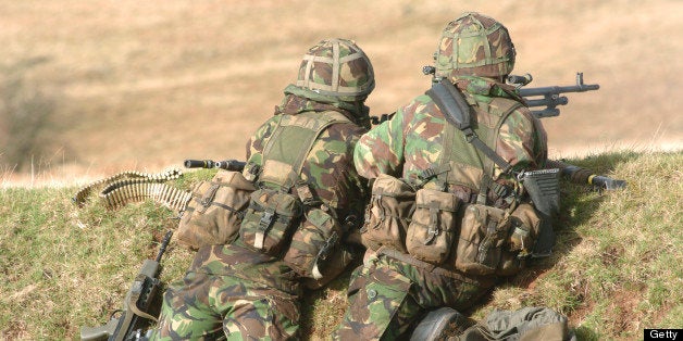 British Army soldiers armed with general purpose machine guns participate in sustained fire training at Brecon Beacons, South Wales.