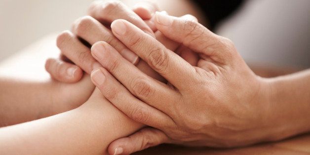Cropped image of hands as one person consoles another