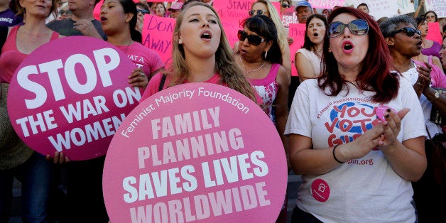 Planned Parenthood supporters rally for women's access to reproductive health care on ``National Pink Out Day'' at Los Angeles City Hall, Tuesday, Sept. 29, 2015. (AP Photo/Nick Ut)