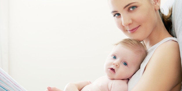 mother and baby lying on bed