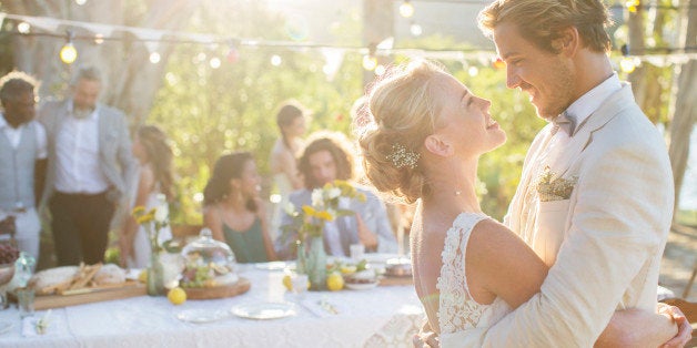 Young couple dancing during wedding reception in domestic garden