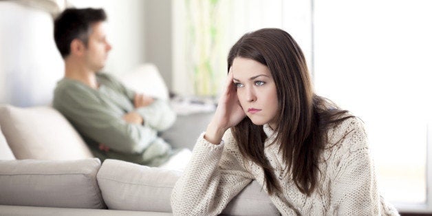 Young couple having relationship difficulties, shallow depth of field focus on foreground