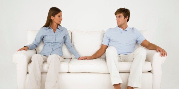 Couple holding hands on couch