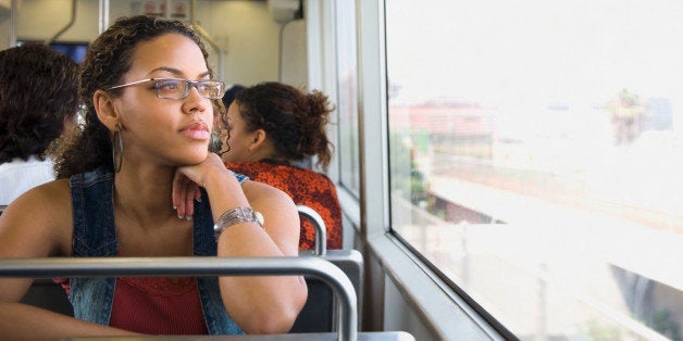 African woman riding on train