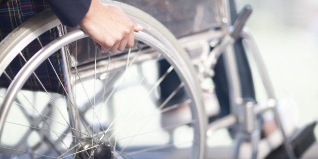 Woman turning wheel of wheelchair