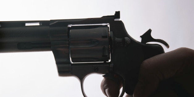 Hand holding gun, close-up, side view