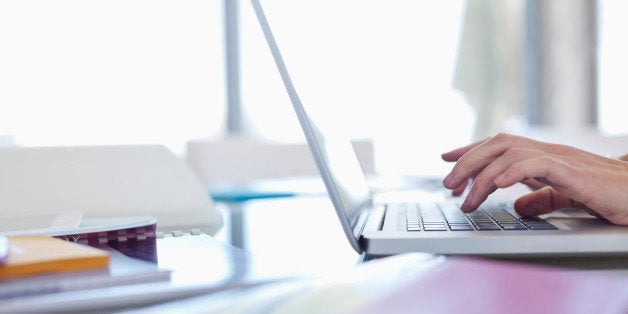 Businesswoman using laptop at desk