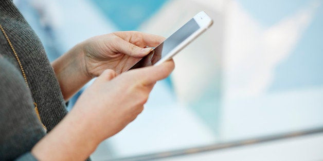 A woman holding a smart phone.