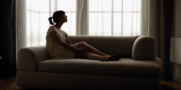 Woman lying down on sofa