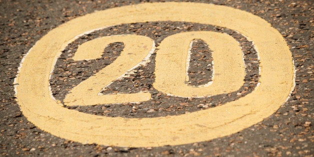 A traffic sign painted in the pavement of a road in Manchester.