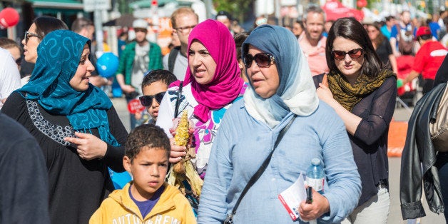 LITTLE PORTUGAL, TORONTO, ONTARIO, CANADA - 2015/06/06: Islam women wearing hijab in North American city, Multicultural city celebrates together the Dundas West Festival in Little Portugal, the festival is a traditional event held every year. (Photo by Roberto Machado Noa/LightRocket via Getty Images)