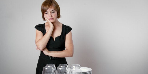 worried woman setting the table ...